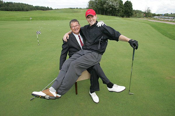 Brett and Michael Brasier sharing a lighter moment on the practice green