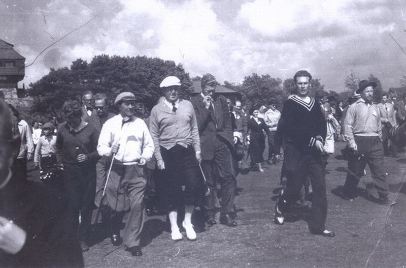 Douglas Brasier playing a round with King Carl XVI Gustaf of Sweden, followed by an entourage